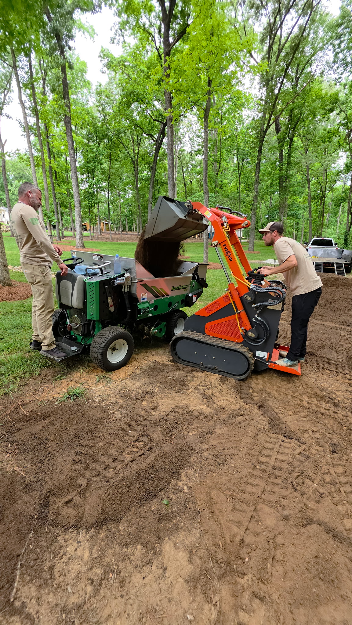 Top dressing equipment being loaded on a residential job site